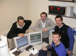 The team inspecting one of their devices. (from left) T.F. Krauss, L. O'Faolain, T.P. White and D. Beggs. 